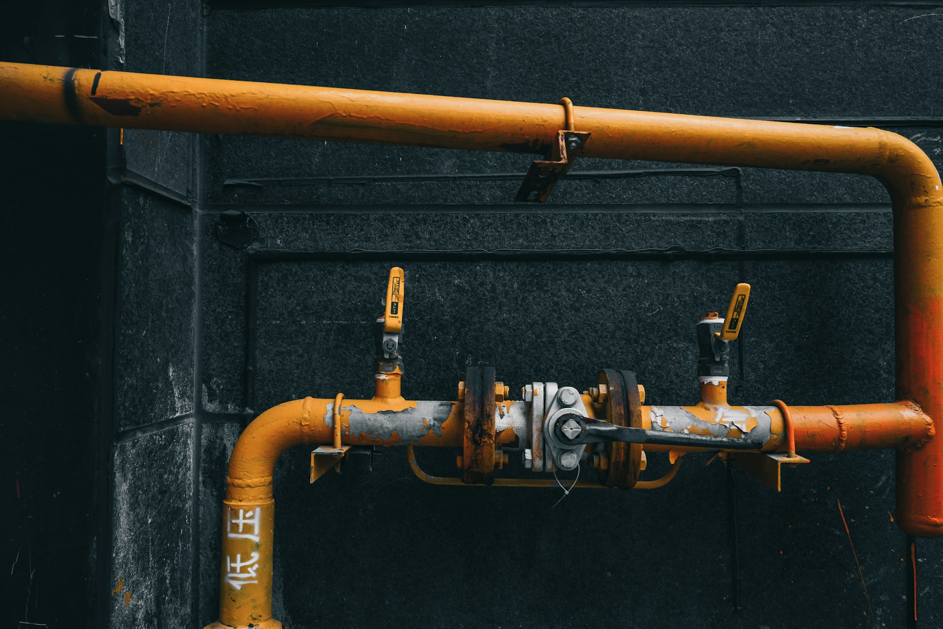 brass pipe with pipe on black wall